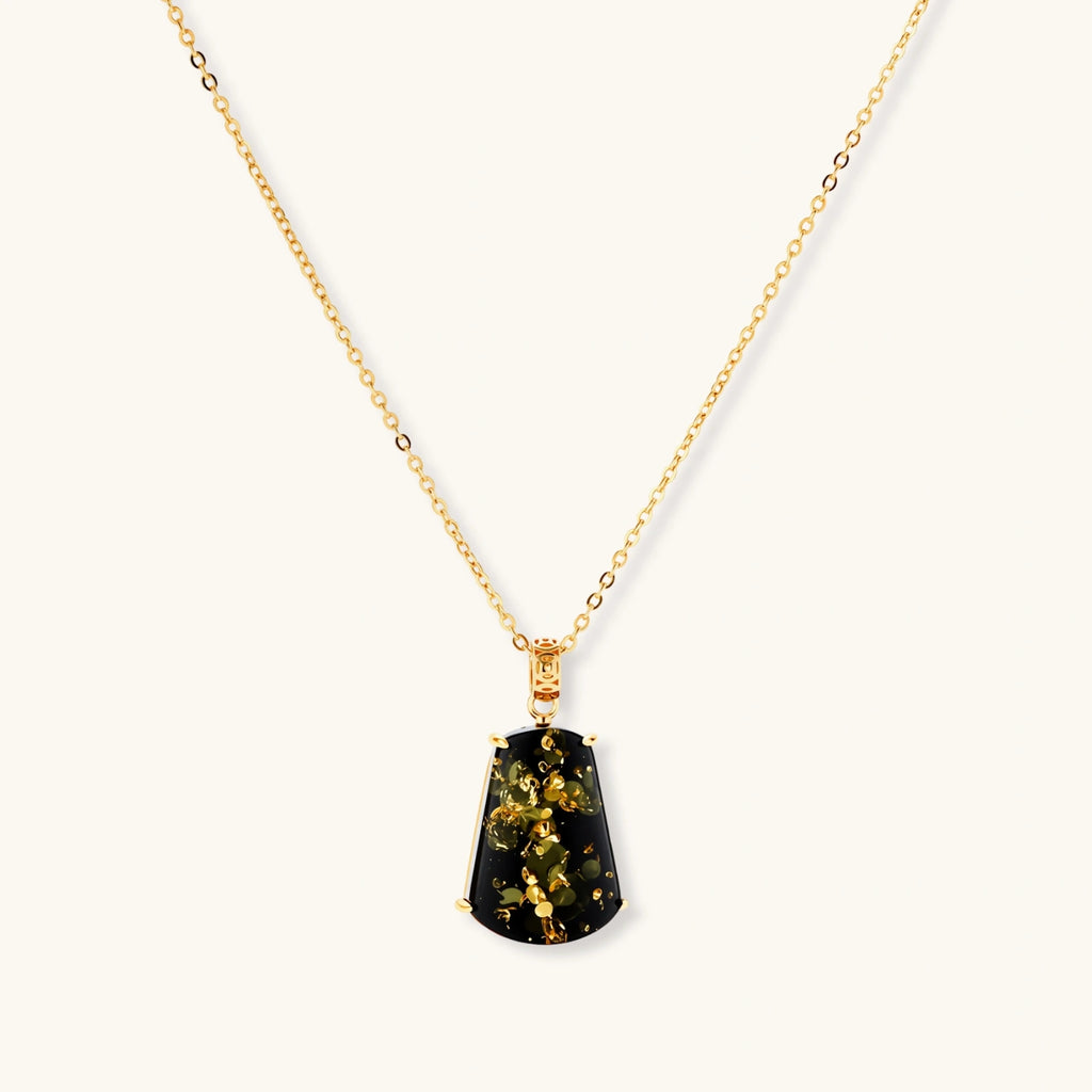18k gold-plated necklace and earrings with green amber pendants featuring golden inclusions on cream background