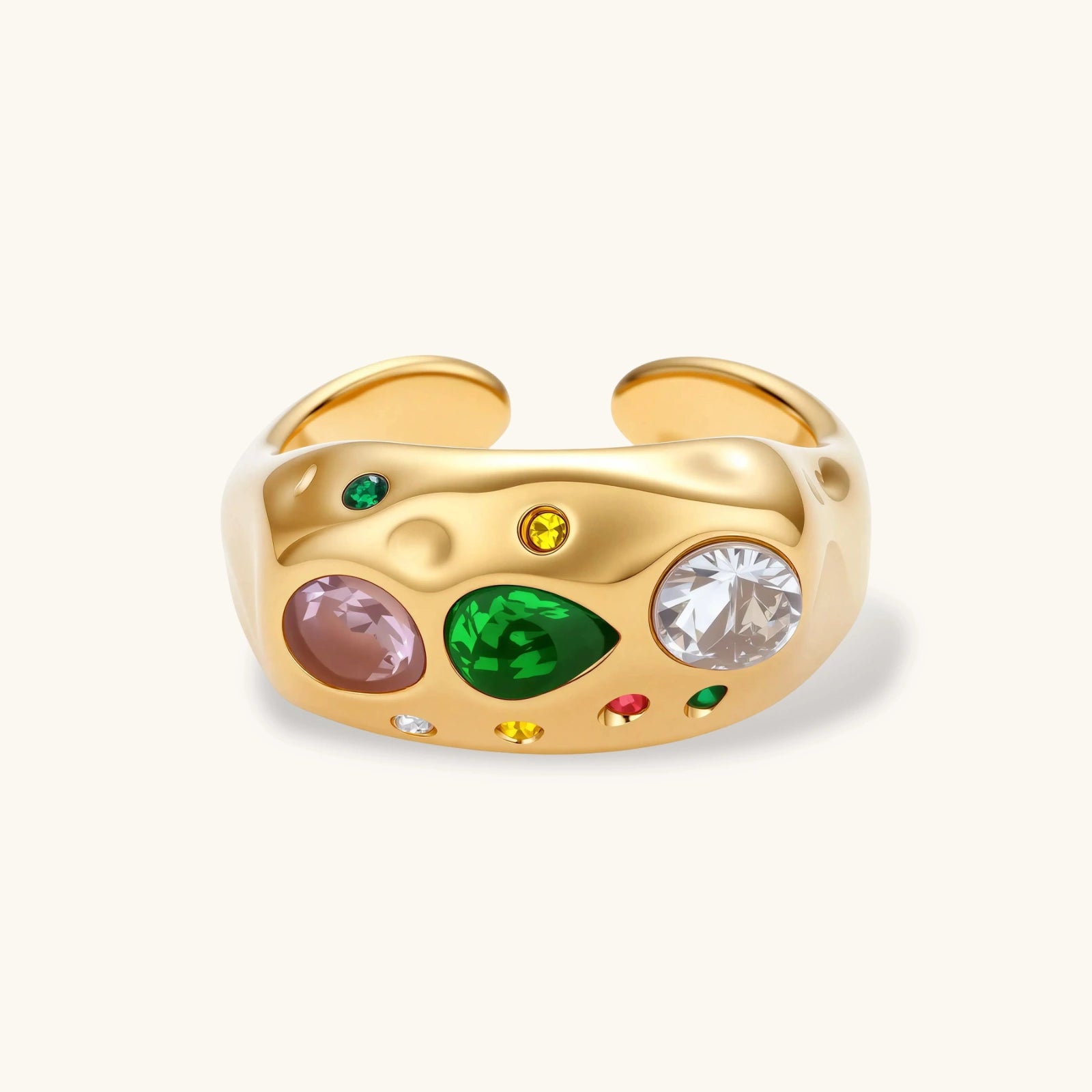 Gold-plated adjustable dome ring with pink, green, white, red, and yellow cubic zirconia stones on cream background.
