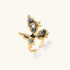 Gold-plated adjustable ring featuring iridescent shell pieces in purple, blue and green tones arranged in butterfly formation