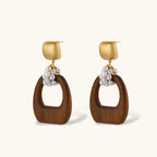 Gold-plated stud earrings with pearl clusters and organic brown wooden hoops on cream background